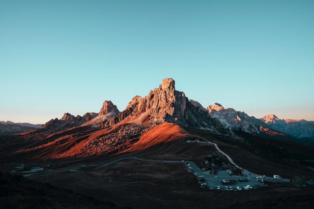 A scenic view of a mountain range during sunset.