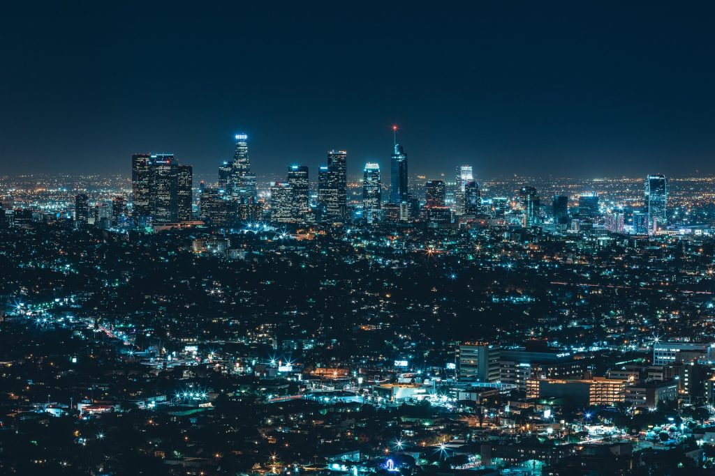 A modern city at night, seen at distance and from an elevated vantage point