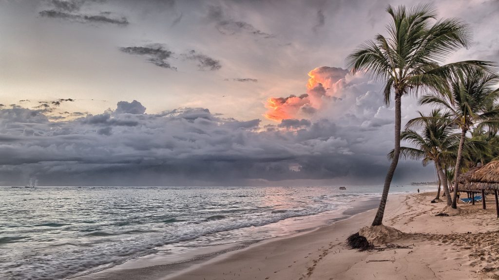 A serene beach with clear blue water and white sand.